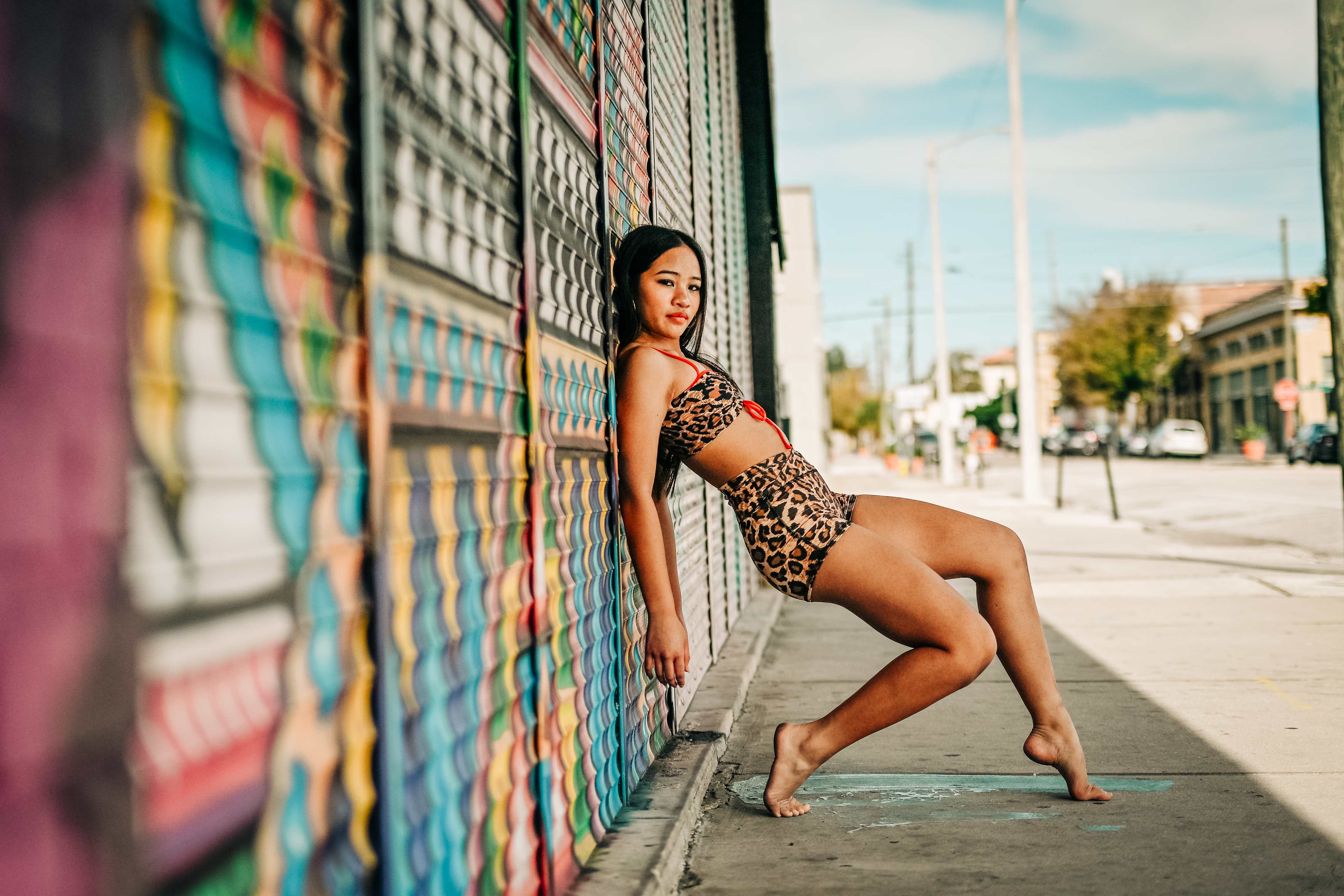 Richani leaning back against a mural wall in a dramatic lunge pose